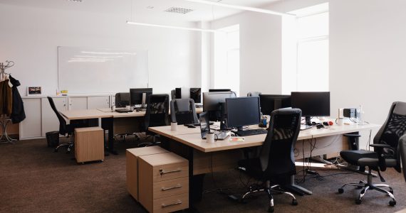 IT open space office. Computer Work Stations. Office Workplace with windows.