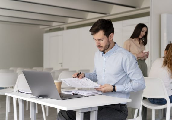 young-business-man-working-her-desk-with-laptop